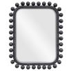 Wall mirror lined with black wooden spheres