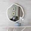 A organically shaped mirror with a stunning stone finish