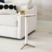 Glamorous, slender side table crafted from white marble with brass accents