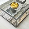 Sleek coffee table with eye-catching marble base and grey minimal frame with glass top