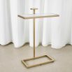 Elegant and understated tall side table with white surface and brass frame