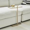 Elegant and understated tall side table with white surface and brass frame