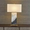 Black and white marble lamp with brass base and rectangular linen shade