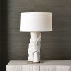 A stylish side lamp by Uttermost with a white ceramic sculptural base and white textured cotton shade
