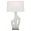 Ivory man-made stone lamp resting on simple antique brass base