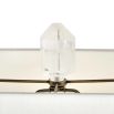 Rich brass table lamp with floating crystal quartz between metal frame