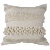 Cream coloured cushion with rows of various tufted textures and bobbles