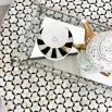 A luxury bone inlay coffee table with a round and geometric design elevated on a brass base