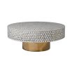 A luxury bone inlay coffee table with a round and geometric design elevated on a brass base