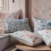 A beautiful, blush-coloured cushion with a floral design