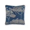 A dark blue square cushion with a contrasting beige coloured tree decoration
