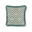 A fringed outdoor cushion with various green hues and chevron details.