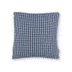 A blue houndstooth knitted outdoor cushion