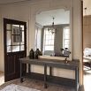 A light grey mirror with rustic, French charm and a distressed finish