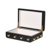An elegant black box with golden studded details