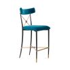 A chic empire-style counter stool in blue velvet fabric 