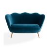 A stylish sofa by Jonathan Adler with a luxury blue upholstery and brass legs