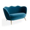 A stylish sofa by Jonathan Adler with a luxury blue upholstery and brass legs