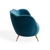 A stylish sofa by Jonathan Adler with a luxury blue upholstery and brass legs