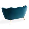 A stylish sofa by Jonathan Adler with a luxury blue upholstery and brass legs