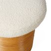 A luxurious cream boucle topped rattan stool