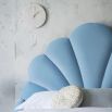 Luxury, curvaceous art-deco bed with a seashell headboard design and tapered legs