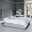 Art deco chic style bed with a towering deep fluted panel headboard 