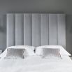 Art deco chic style bed with a towering deep fluted panel headboard 