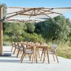 A stylish Scandinavian style outdoor dining chair with a stunning sunbrella cushion upholstery and natural frame