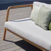 A stylish outdoor sofa from Skyline Design with a dreamy off-white sunbrella upholstery 