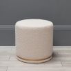 An elegant bespoke pouffe with a brass-effect accent