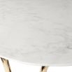 contemporary marble table with a single sinuous brass tube base 