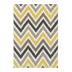 Hand-tufted wool rug with chevron pattern in yellow