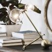 Industrial style table lamp in a natural brass finish with clear glass lampshade design