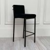 A gorgeous black velvet and bronze bar stool
