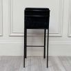 A gorgeous black velvet and bronze bar stool