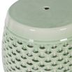 A stylish sage green stool with a ceramic pattern 