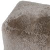 A luxury pouffe with a taupe sheepskin upholstery 