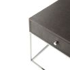 A stylish side table with a shagreen-embossed leather top and polished nickel base