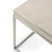 A stylish side table with a shagreen leather top and cube-shaped, polished nickel base
