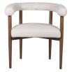 Cosy Scandinavian style dining chair with a rounded wrap-around boucle backrest and sumptuous boucle seat