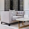 ex-display armchair in grey upholstery with fluting and deep stitching details
