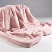 A sumptuous soft pink faux fur throw with a faux suede reverse