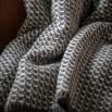 Grey and white cross knit throw