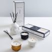 A contemporary glossy white fragranced room diffuser by Jonathan Adler