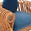The St Tropez Lounge Chair blends coastal charm and haute couture with hand-coiled reeds and blue velvet cushions, finished with satin lacquer.