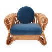 The St Tropez Lounge Chair blends coastal charm and haute couture with hand-coiled reeds and blue velvet cushions, finished with satin lacquer.