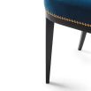 Deeply curved dining chair with studding and buttons