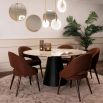 Round and tapered dining table with artisanal central leg