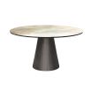 Round and tapered dining table with artisanal central table leg